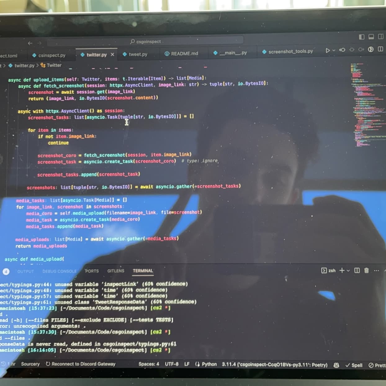 a reflection of me (Nathan Lodge) holding up a peace sign in front of a laptop with Visual Studio Code open